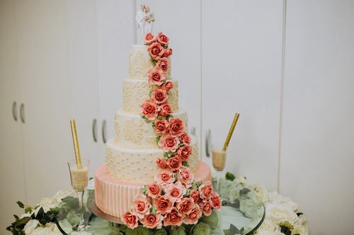 white cake decorated with red roses