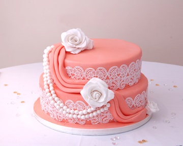 pink cake with white filagree