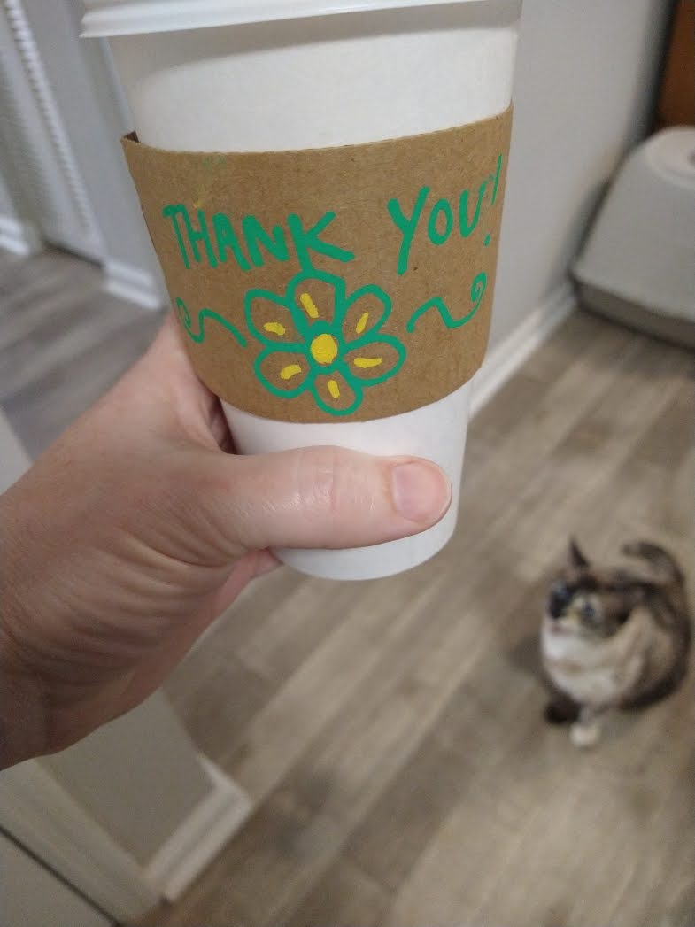 hand-written thank you on a coffee sleeve